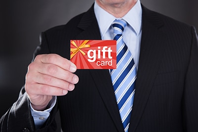 Closeup of businessman holding a gift card